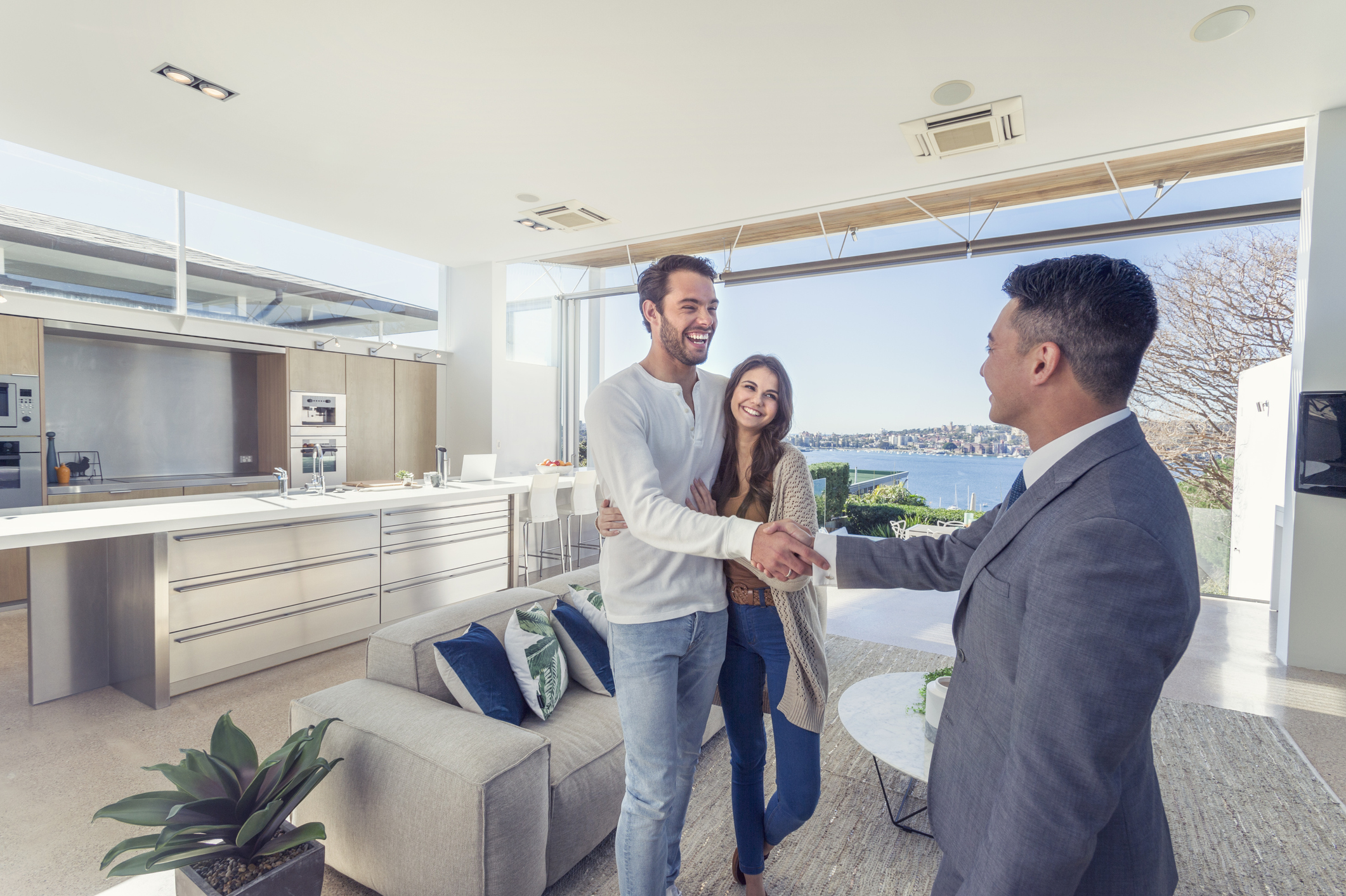 real estate agent showing couple a luxury home