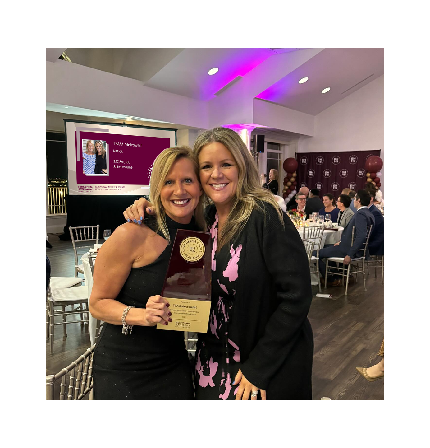 Robin and Nicole posing with their award at an awards gala